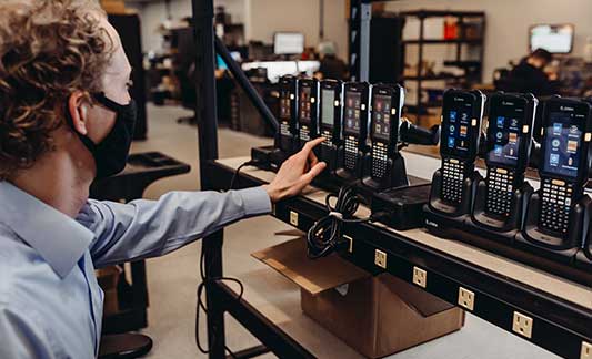 barcoding_employee_setting_up_mobile_scanners